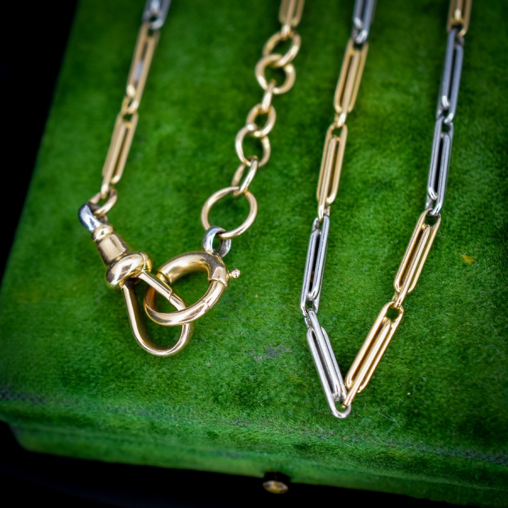 An antique two-tone chain necklace featuring alternating 18ct yellow gold and platinum elongated links with a dog clip and bolt ring clasp. View VI