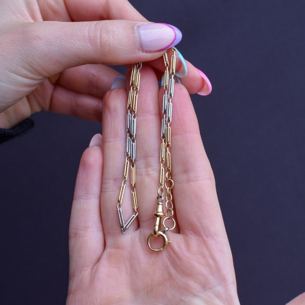 An antique two-tone chain necklace featuring alternating 18ct yellow gold and platinum elongated links with a dog clip and bolt ring clasp. View IX