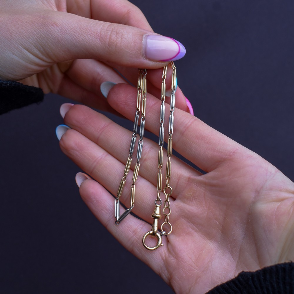 An antique two-tone chain necklace featuring alternating 18ct yellow gold and platinum elongated links with a dog clip and bolt ring clasp. View X