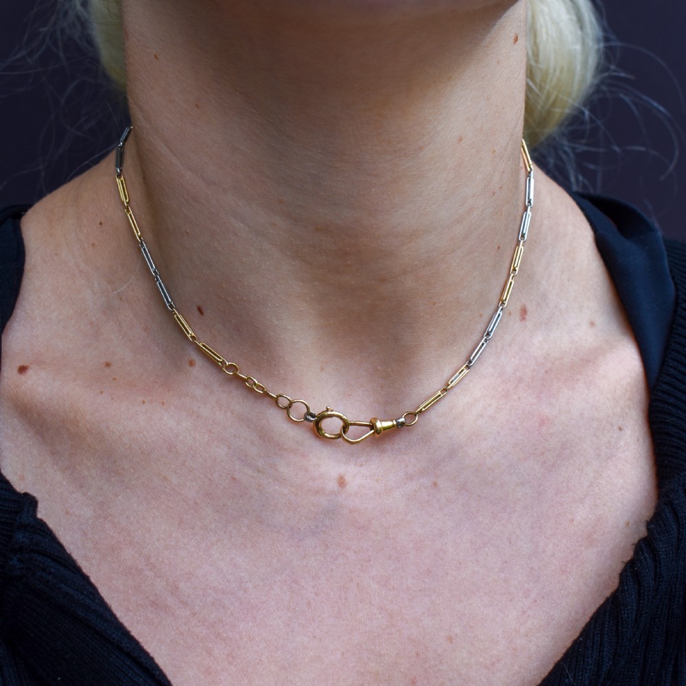 An antique two-tone chain necklace featuring alternating 18ct yellow gold and platinum elongated links with a dog clip and bolt ring clasp. View XI