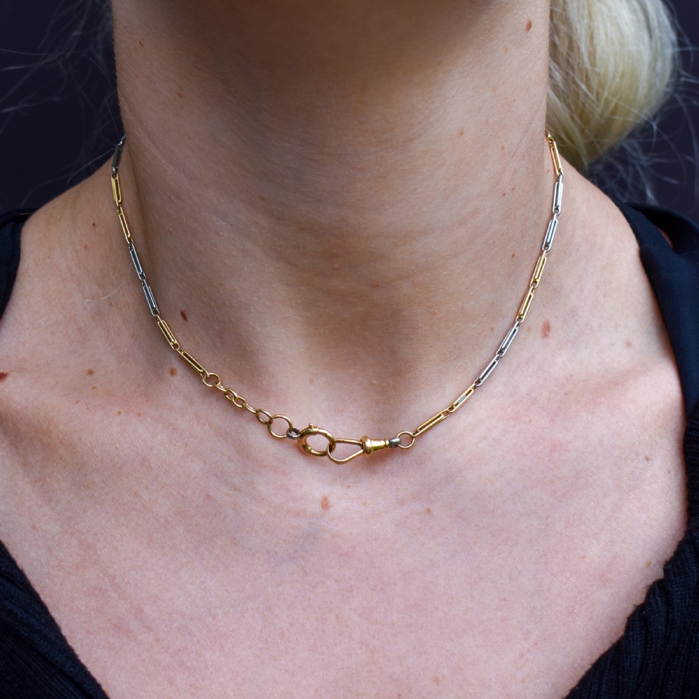 An antique two-tone chain necklace featuring alternating 18ct yellow gold and platinum elongated links with a dog clip and bolt ring clasp. View XII