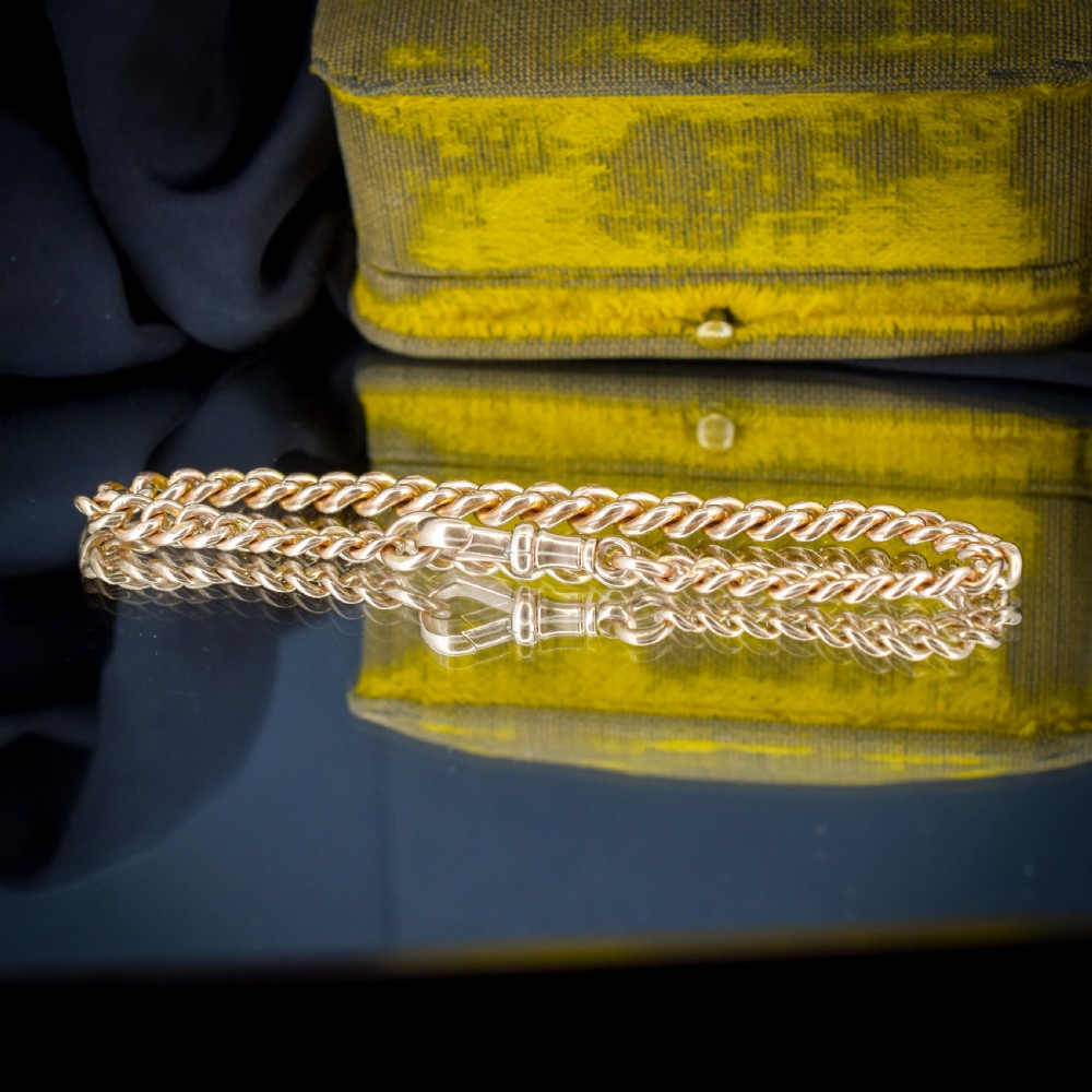 An antique 9ct yellow gold curb link chain bracelet with a swivel dog clip clasp. View IV
