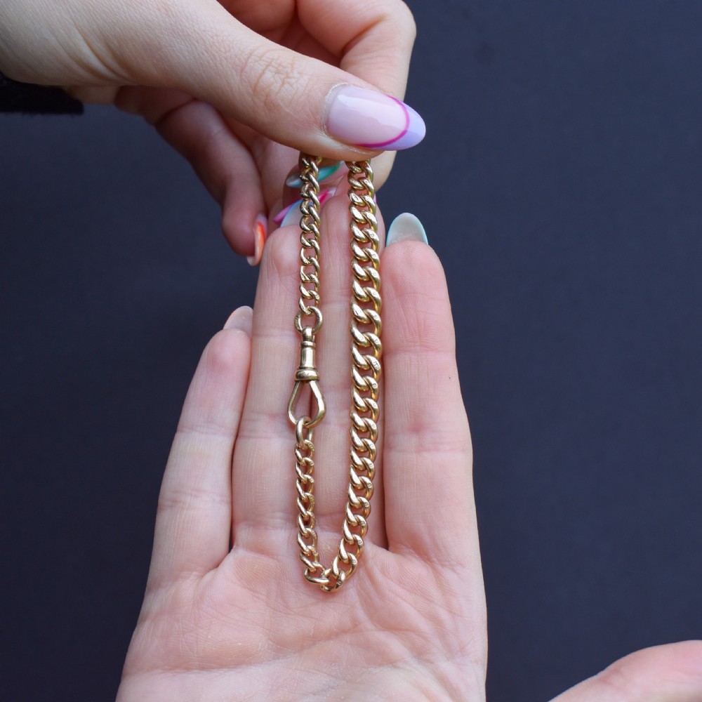 An antique 9ct yellow gold curb link chain bracelet with a swivel dog clip clasp. View X
