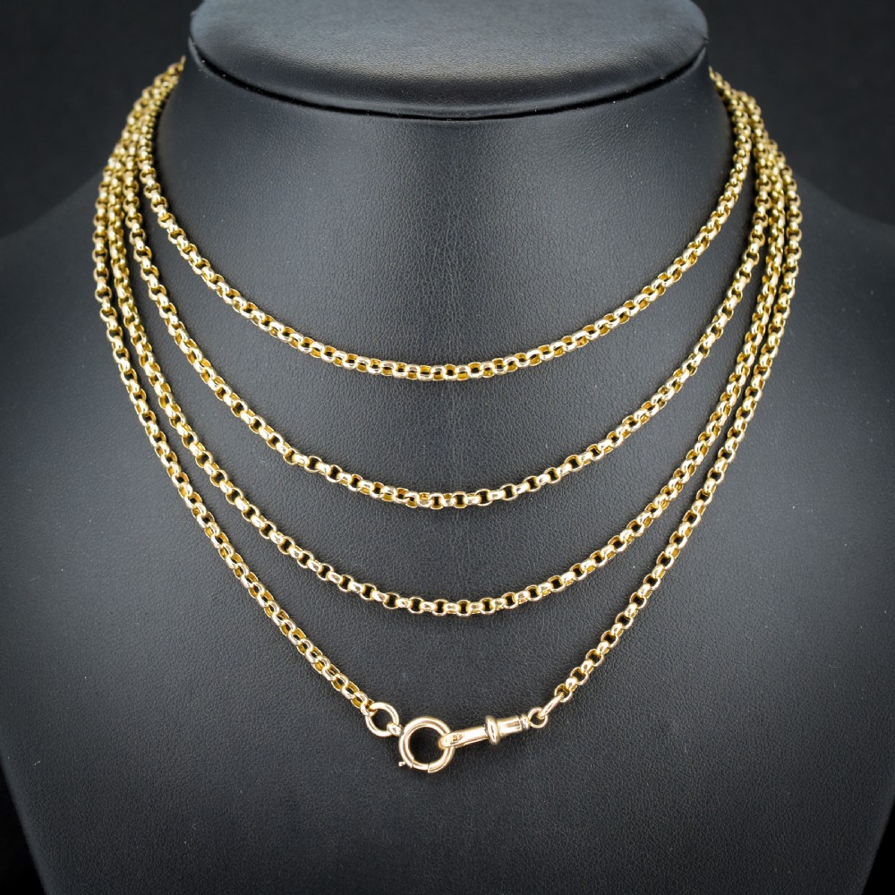 A long 9ct yellow gold Victorian guard chain featuring circular belcher links layered in four loops, secured with a swivel clasp.