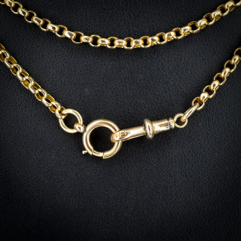 A long 9ct yellow gold Victorian guard chain featuring circular belcher links layered in four loops, secured with a swivel clasp. View II