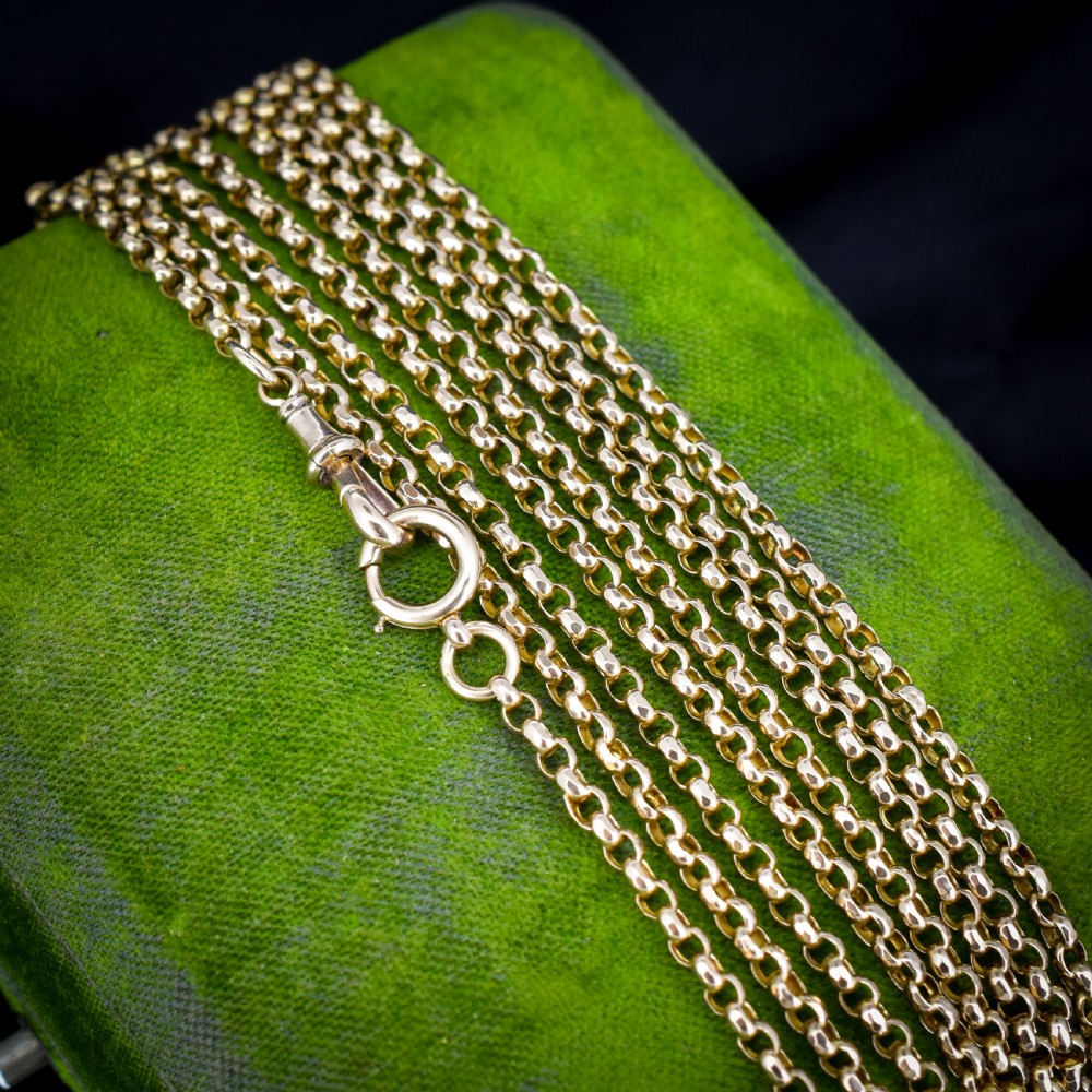 A long 9ct yellow gold Victorian guard chain featuring circular belcher links layered in four loops, secured with a swivel clasp. View IV