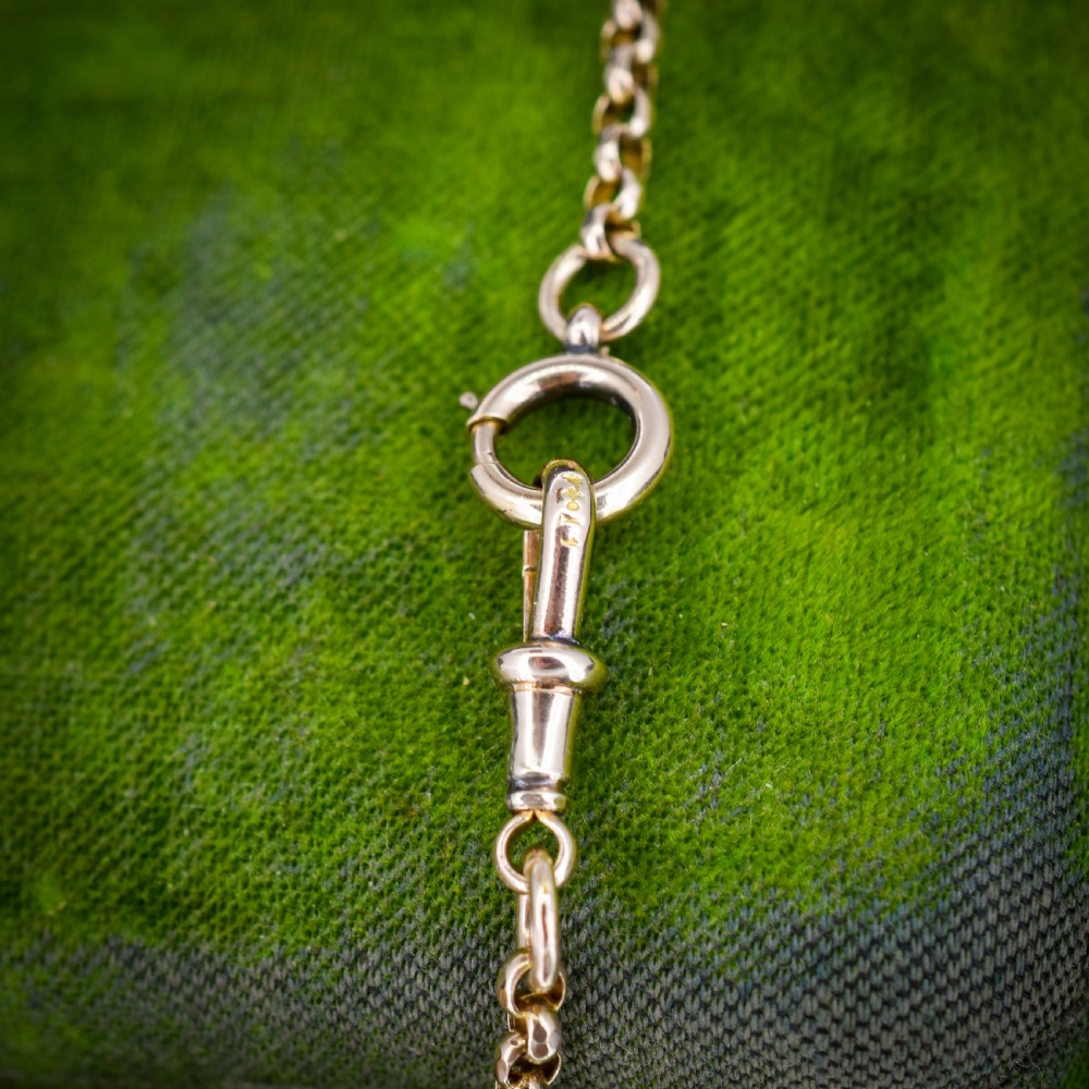 A long 9ct yellow gold Victorian guard chain featuring circular belcher links layered in four loops, secured with a swivel clasp. View V