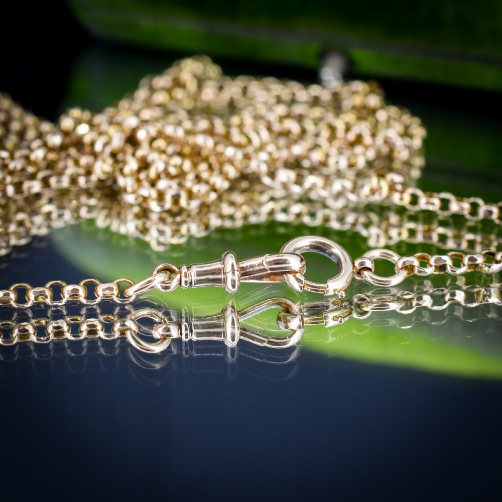 A long 9ct yellow gold Victorian guard chain featuring circular belcher links layered in four loops, secured with a swivel clasp. View VI
