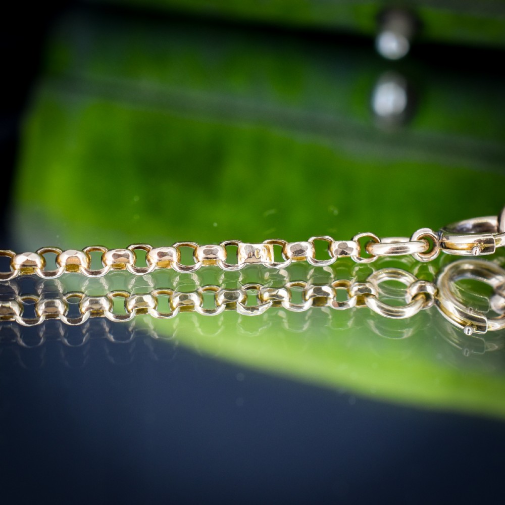 A long 9ct yellow gold Victorian guard chain featuring circular belcher links layered in four loops, secured with a swivel clasp. View VII