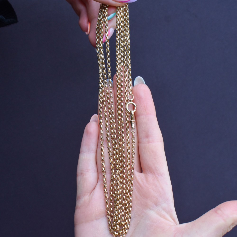 A long 9ct yellow gold Victorian guard chain featuring circular belcher links layered in four loops, secured with a swivel clasp. View VIII