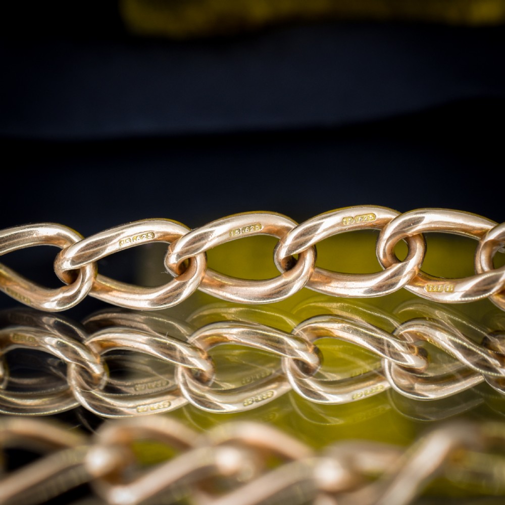 An antique 15ct warm gold oval curb link bracelet featuring stamped links and a dog clip swivel clasp. View IV