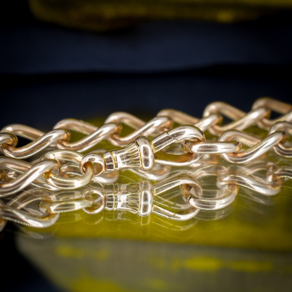 An antique 15ct warm gold oval curb link bracelet featuring stamped links and a dog clip swivel clasp. View V