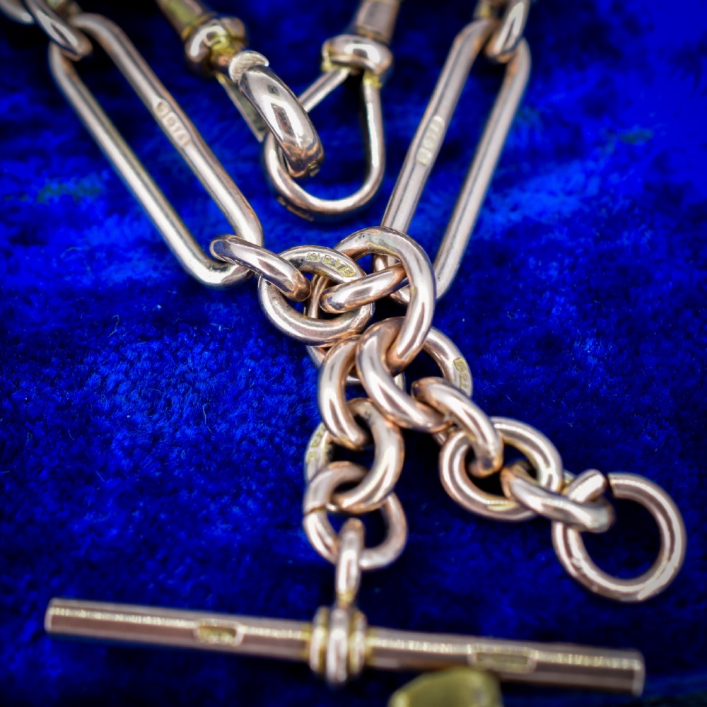 An antique 9ct yellow gold Albert watch chain featuring elongated trombone links, connector rings, a T-bar, and a swivel clasp. View VIII