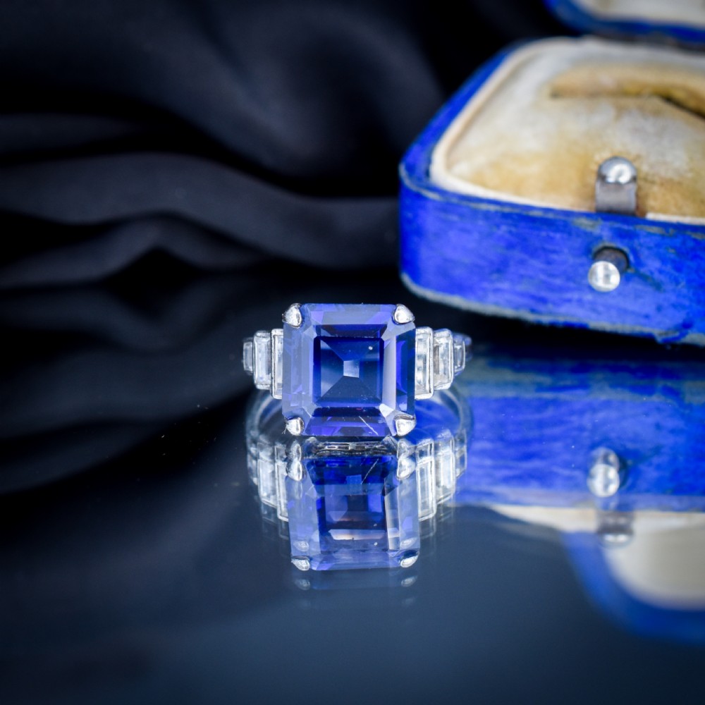 An Art Deco sterling silver cocktail ring set with a large square-cut blue gemstone and stepped baguette-cut side stones. View IV