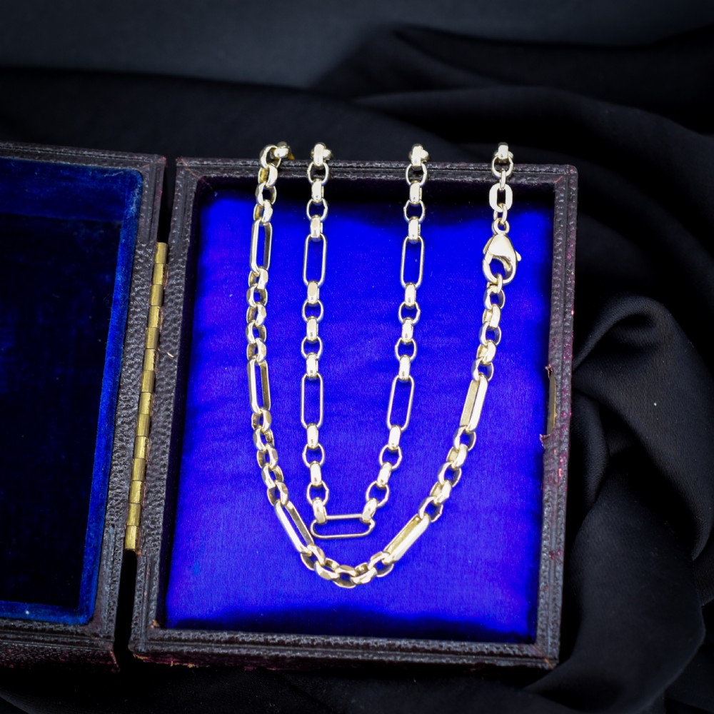 A vintage 9ct yellow gold fancy link chain necklace displayed inside a blue velvet fitted box.