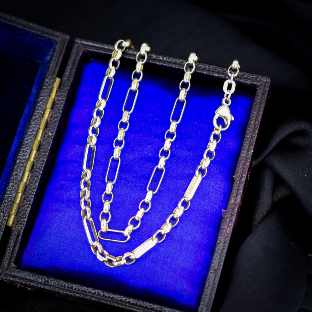 A vintage 9ct yellow gold fancy link chain necklace displayed inside a blue velvet fitted box. View V