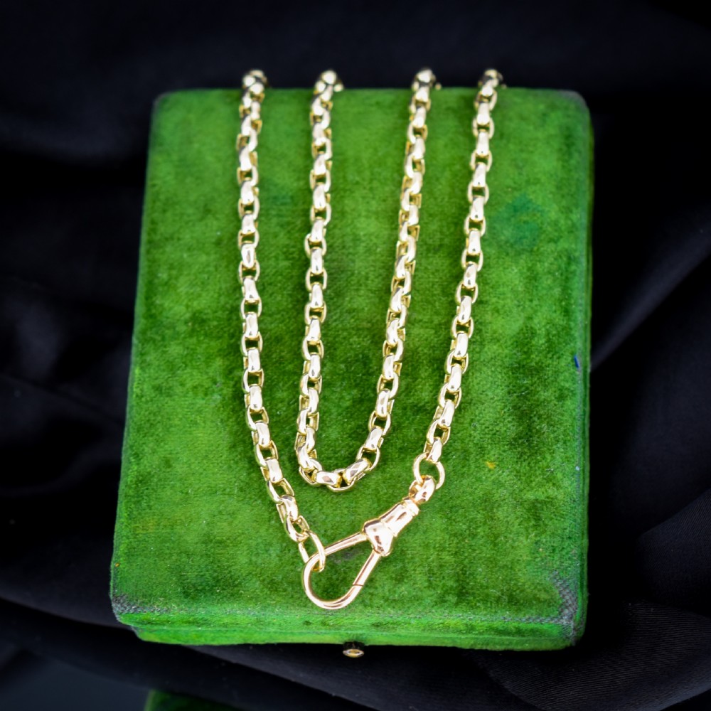 An antique Victorian yellow gold faceted link chain measuring 21.5 inches with a dog clip clasp.