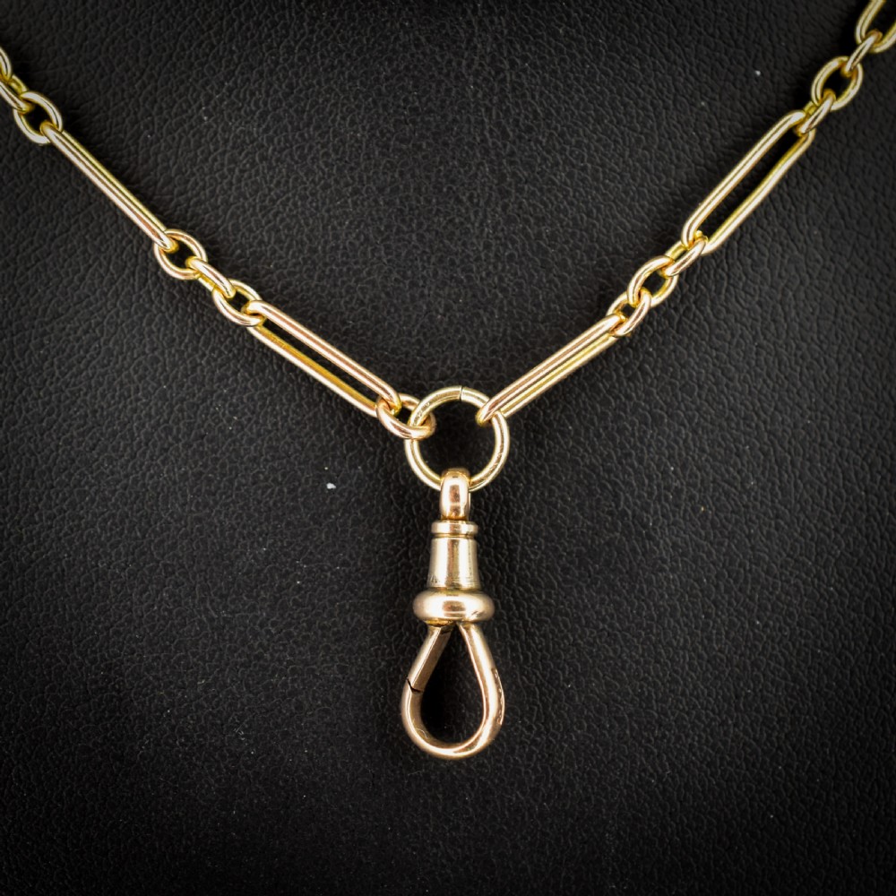An antique long 9ct yellow gold paper link chain necklace layered around a black display bust with a swivel dog clip clasp. View II