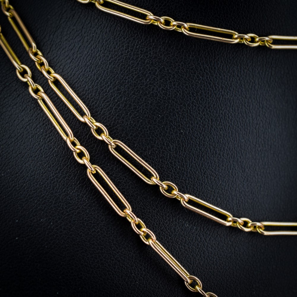 An antique long 9ct yellow gold paper link chain necklace layered around a black display bust with a swivel dog clip clasp. View III