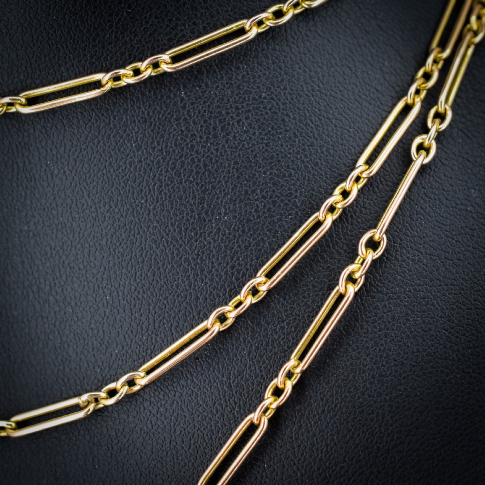 An antique long 9ct yellow gold paper link chain necklace layered around a black display bust with a swivel dog clip clasp. View IV