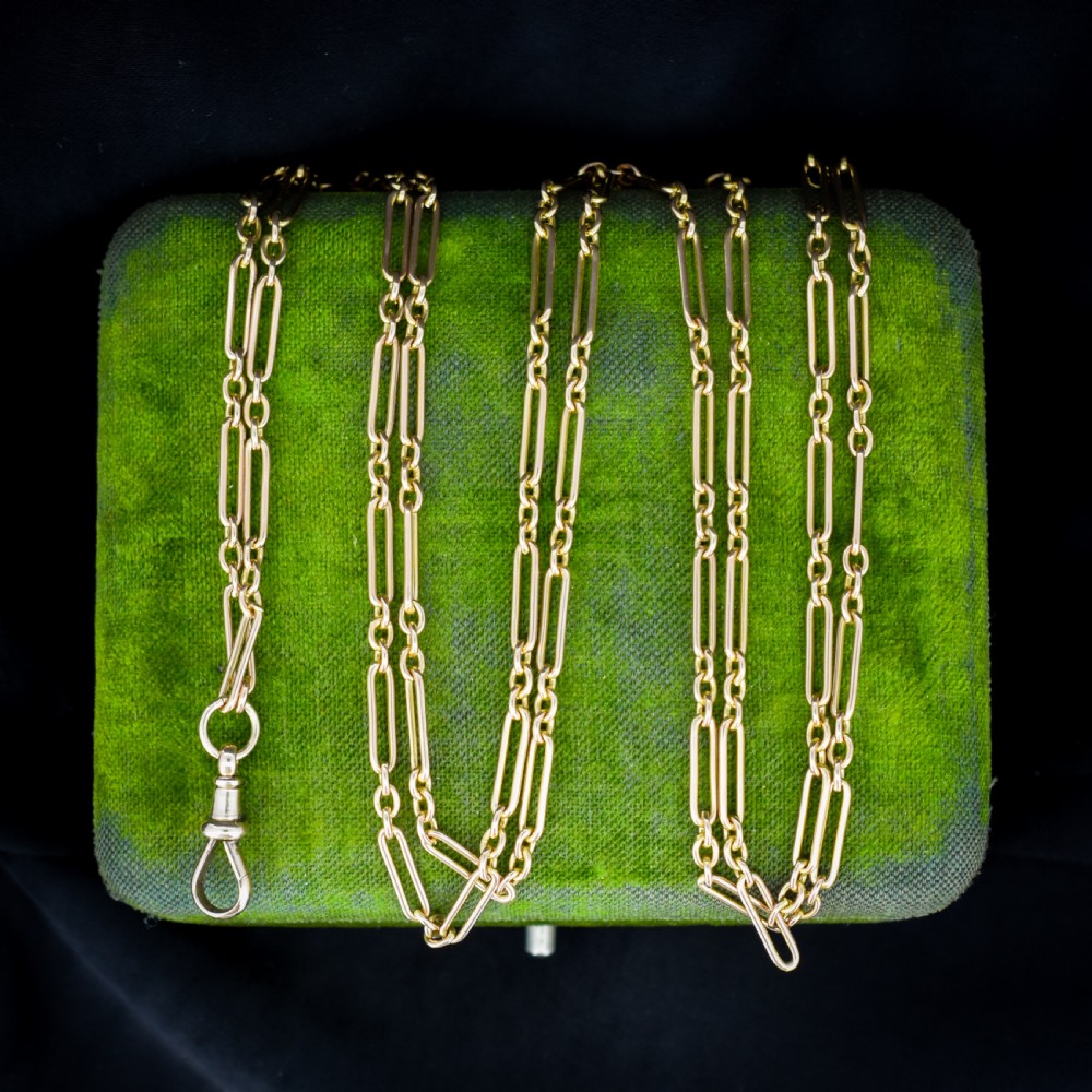An antique long 9ct yellow gold paper link chain necklace layered around a black display bust with a swivel dog clip clasp. View V