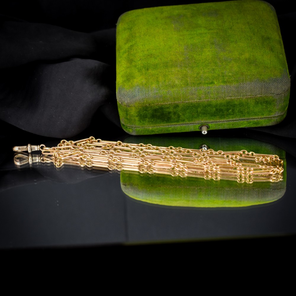 An antique long 9ct yellow gold paper link chain necklace layered around a black display bust with a swivel dog clip clasp. View VII