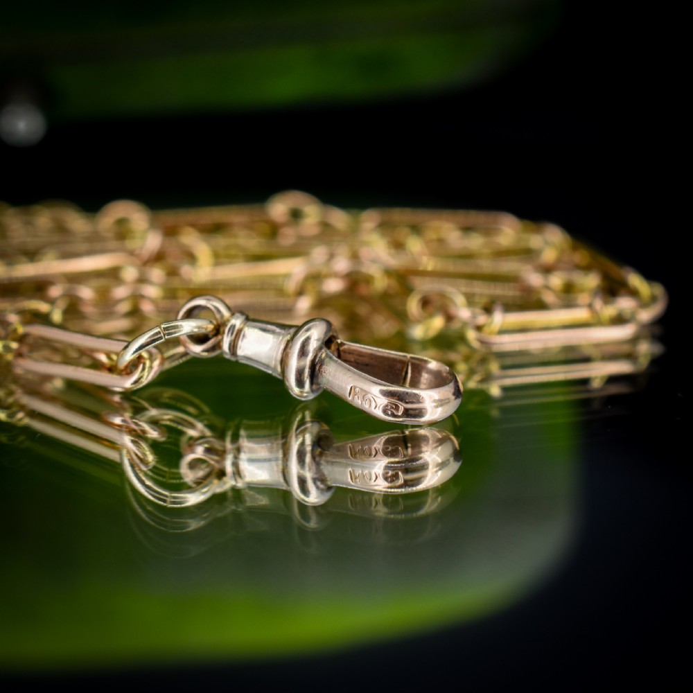 An antique long 9ct yellow gold paper link chain necklace layered around a black display bust with a swivel dog clip clasp. View VIII