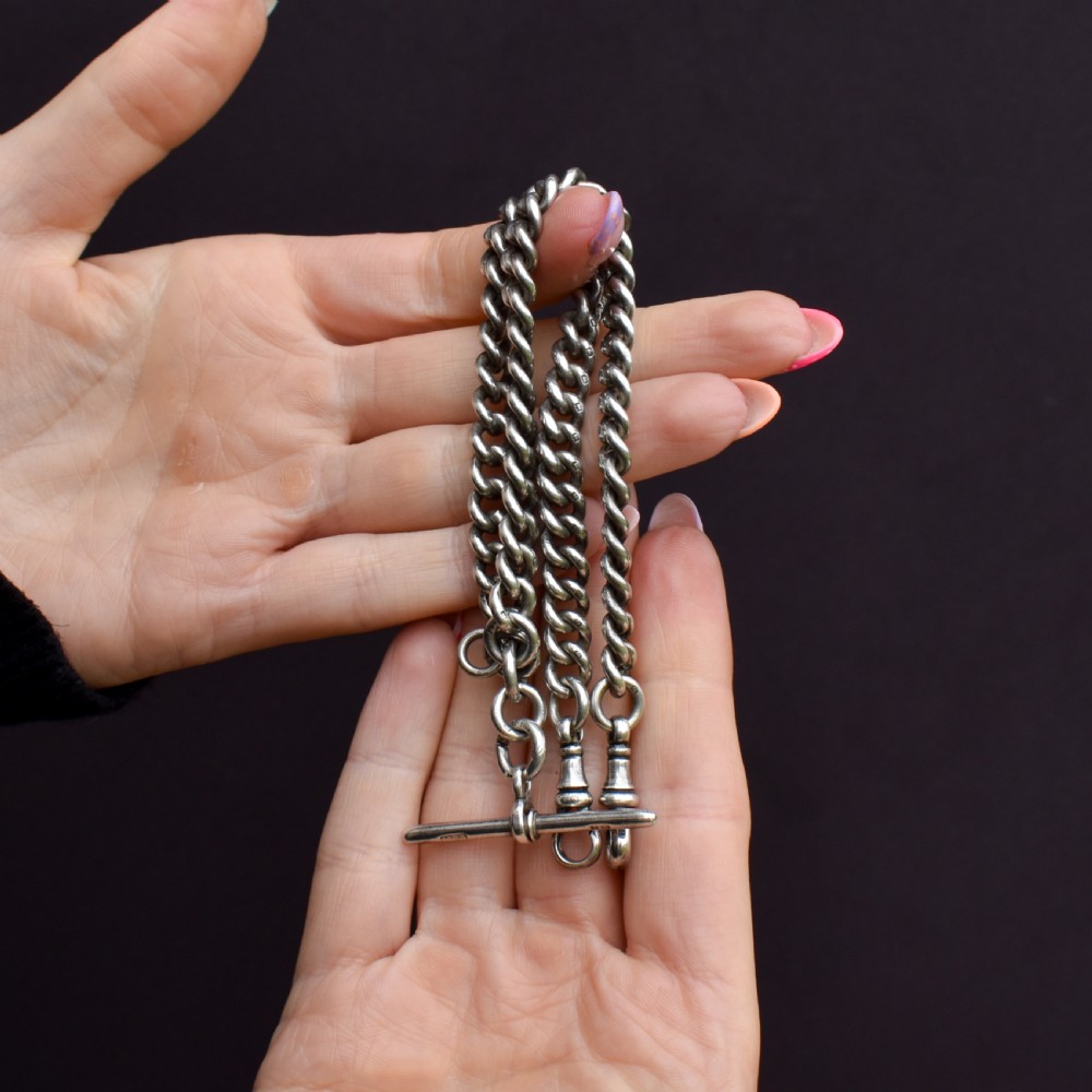 An antique sterling silver curb link Albert watch chain featuring a T-bar fastener and swivel clip. View II