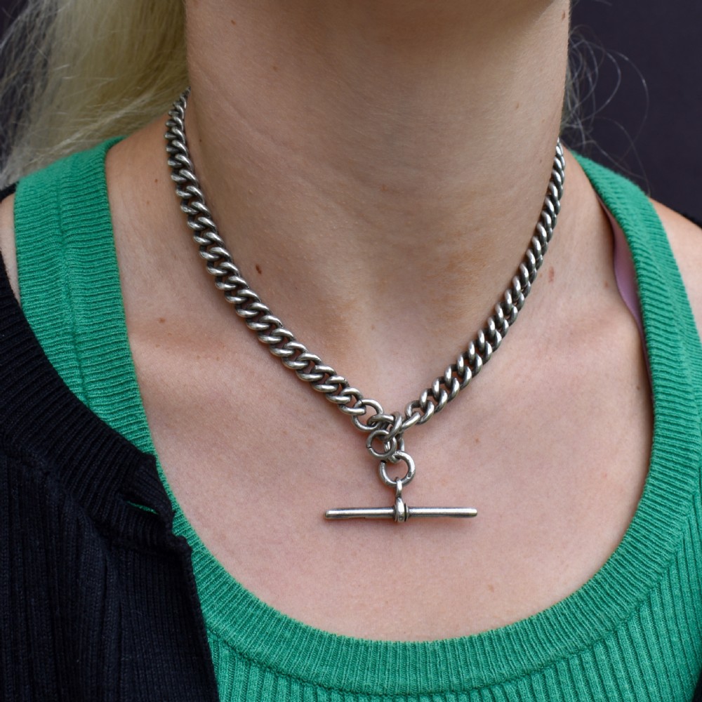 An antique sterling silver curb link Albert watch chain featuring a T-bar fastener and swivel clip. View III