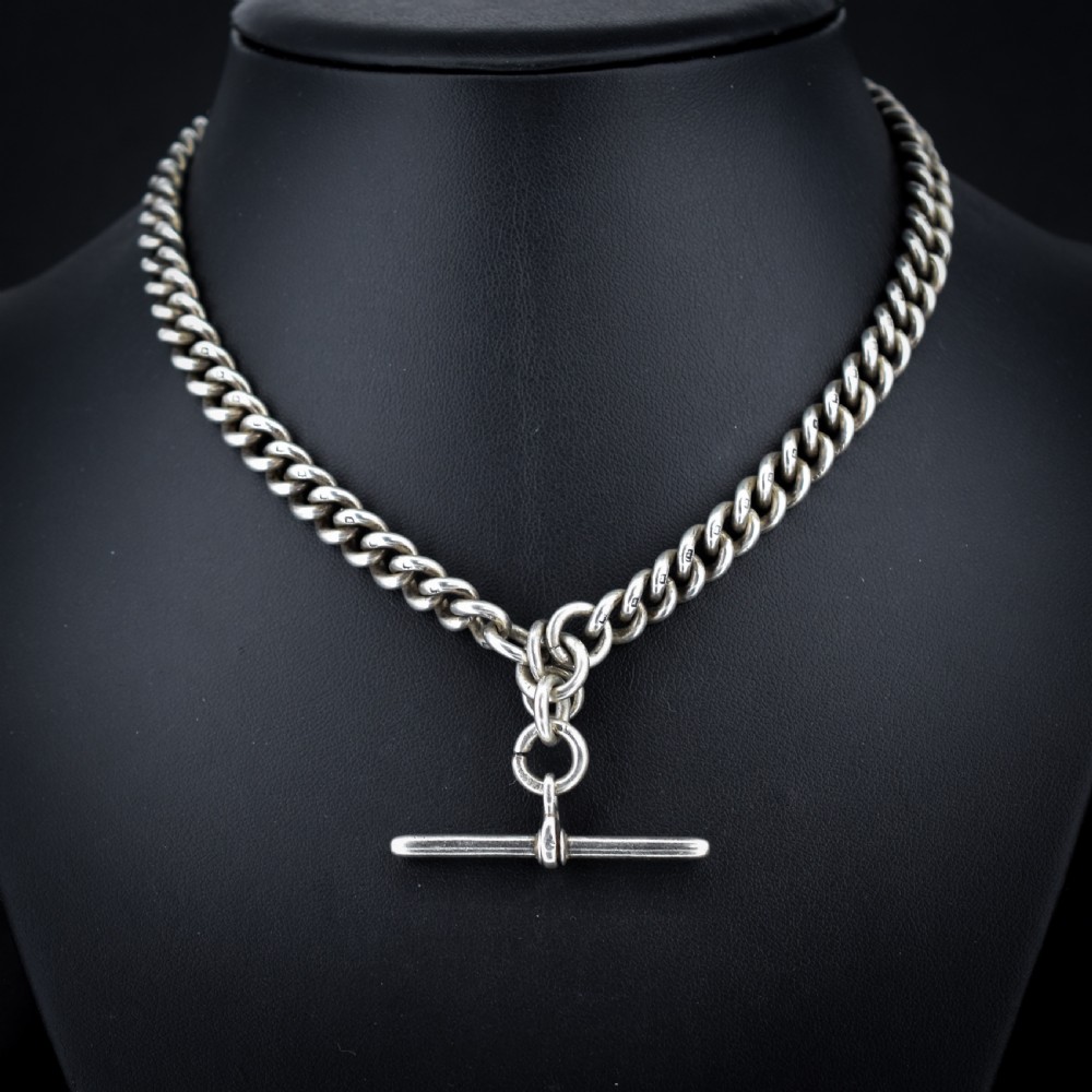 An antique sterling silver curb link Albert watch chain featuring a T-bar fastener and swivel clip. View IV