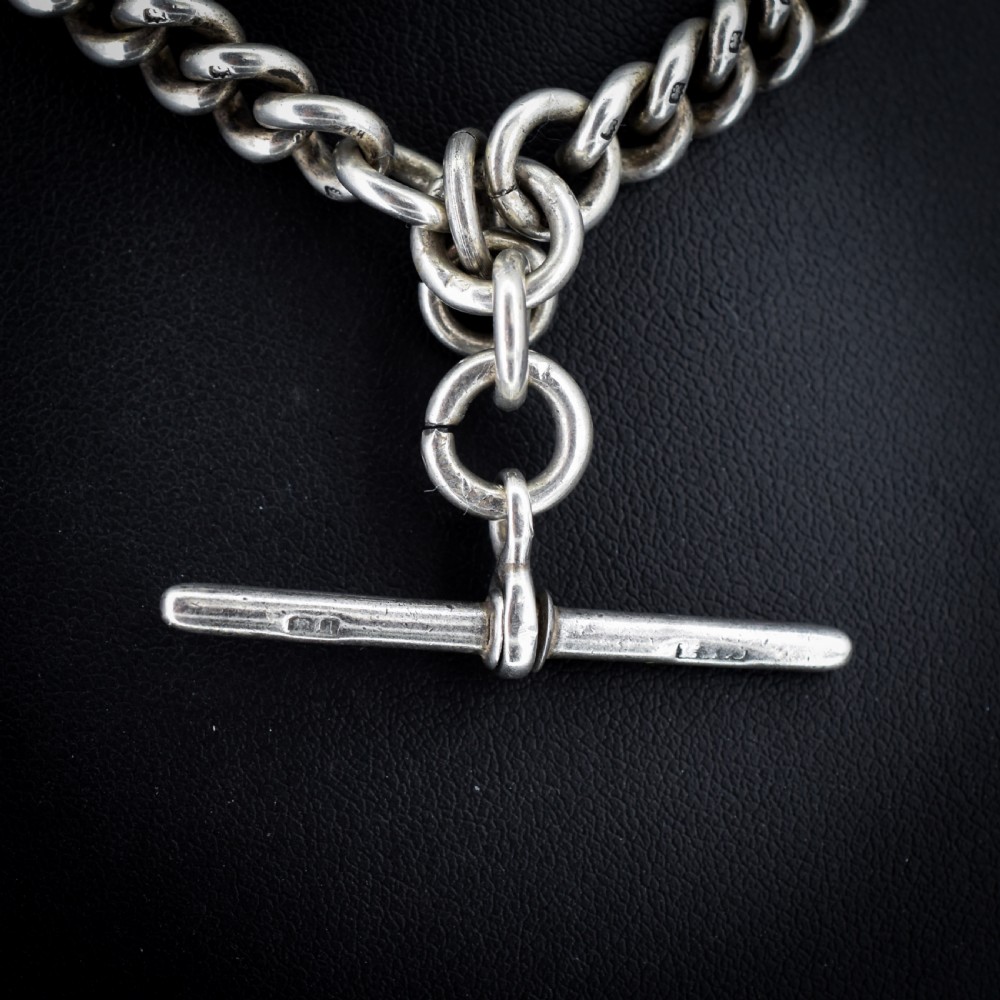An antique sterling silver curb link Albert watch chain featuring a T-bar fastener and swivel clip. View VI