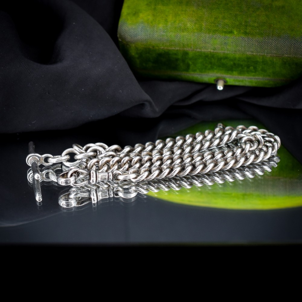 An antique sterling silver curb link Albert watch chain featuring a T-bar fastener and swivel clip. View IX