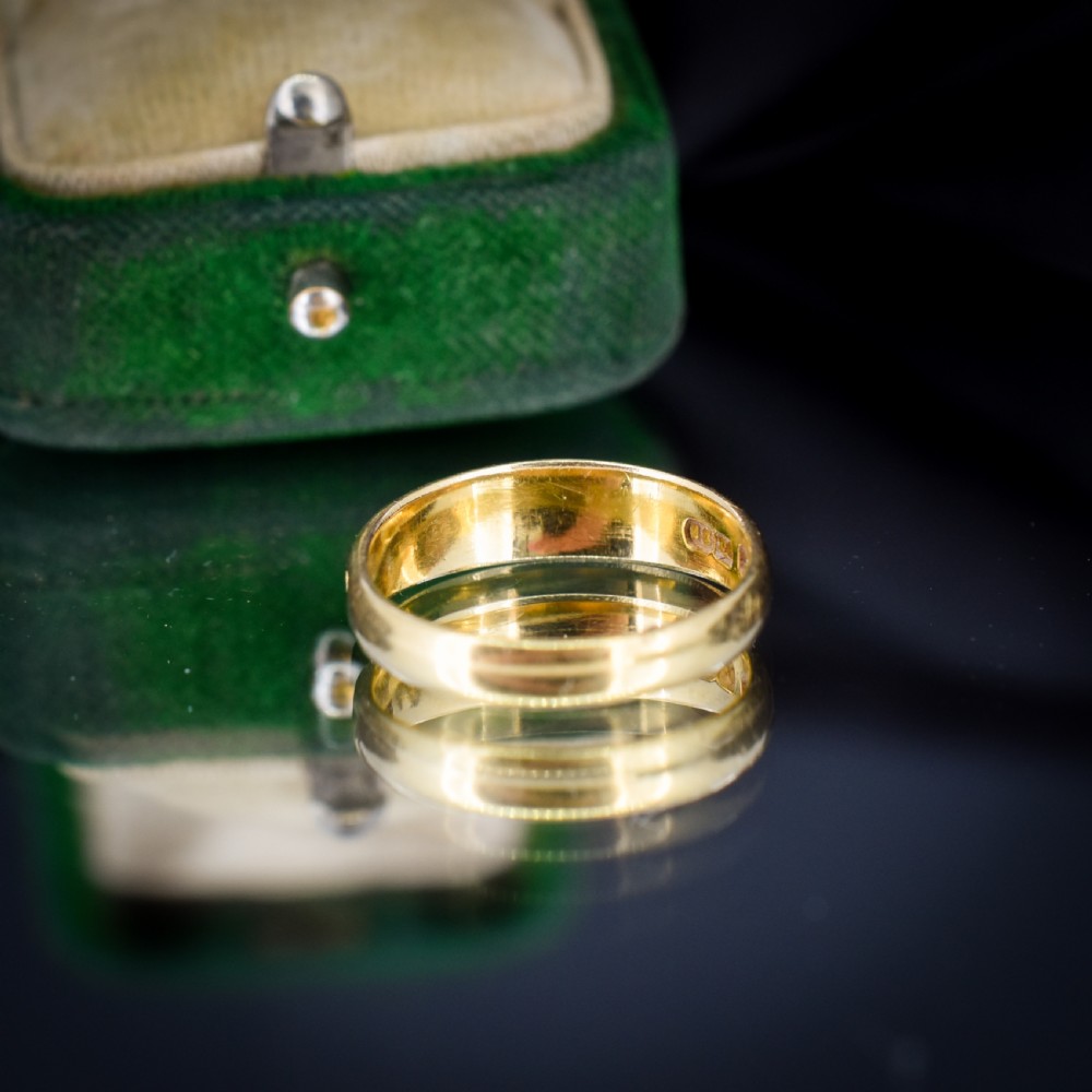 An antique 18ct yellow gold band ring featuring the word MIZPAH in raised capital lettering against a stippled textured background. View IV