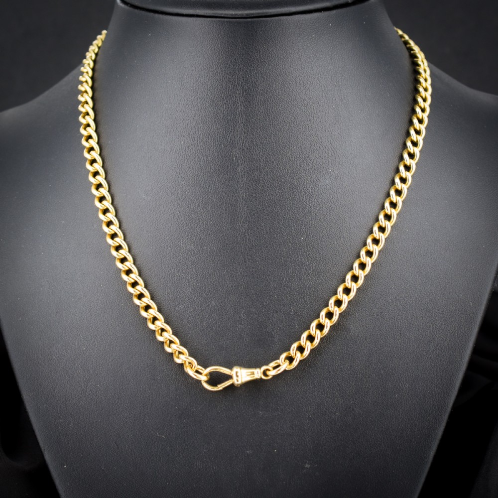 An 18ct yellow gold curb link chain necklace featuring a traditional dog clip fastener. View V