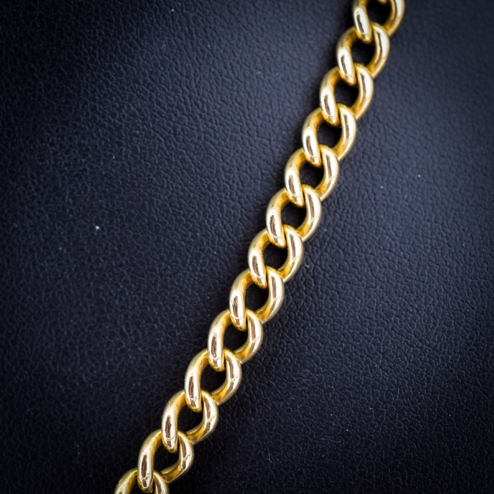 An 18ct yellow gold curb link chain necklace featuring a traditional dog clip fastener. View VII