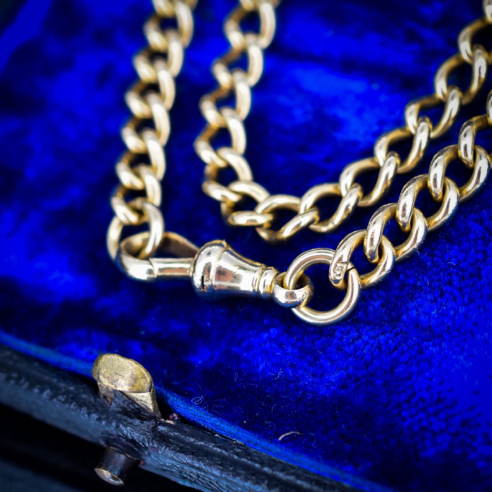An 18ct yellow gold curb link chain necklace featuring a traditional dog clip fastener. View IX