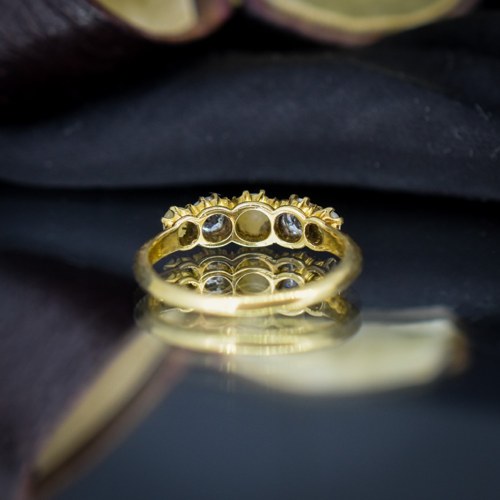 An 18ct yellow gold Victorian five-stone ring featuring three round pearls alternating with two old-cut diamonds. View VII