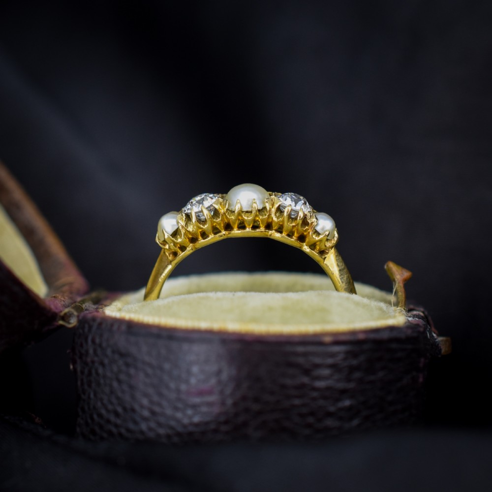 An 18ct yellow gold Victorian five-stone ring featuring three round pearls alternating with two old-cut diamonds. View VIII