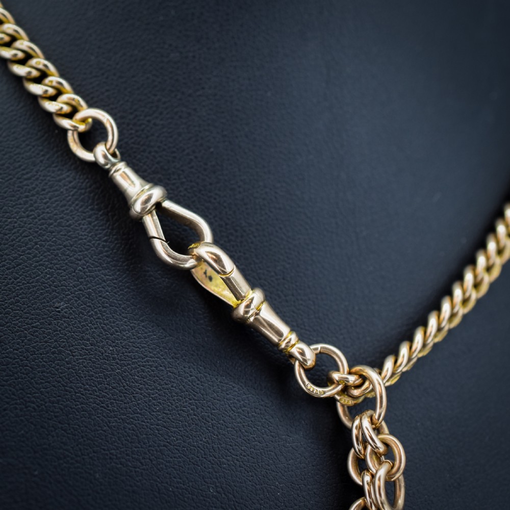 A 9ct yellow gold uniform curb link Albert watch chain featuring a T-bar and dog clip fastings. View V