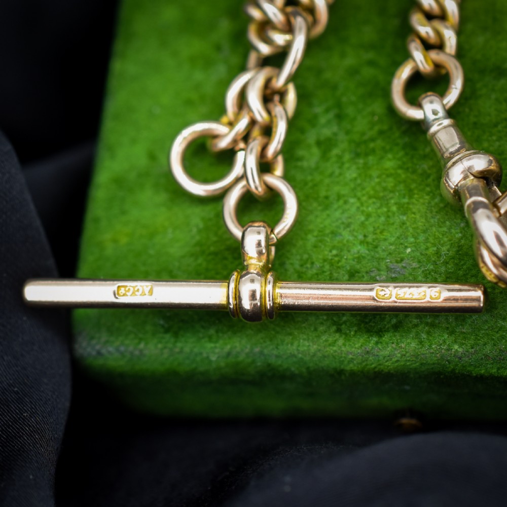 A 9ct yellow gold uniform curb link Albert watch chain featuring a T-bar and dog clip fastings. View VI