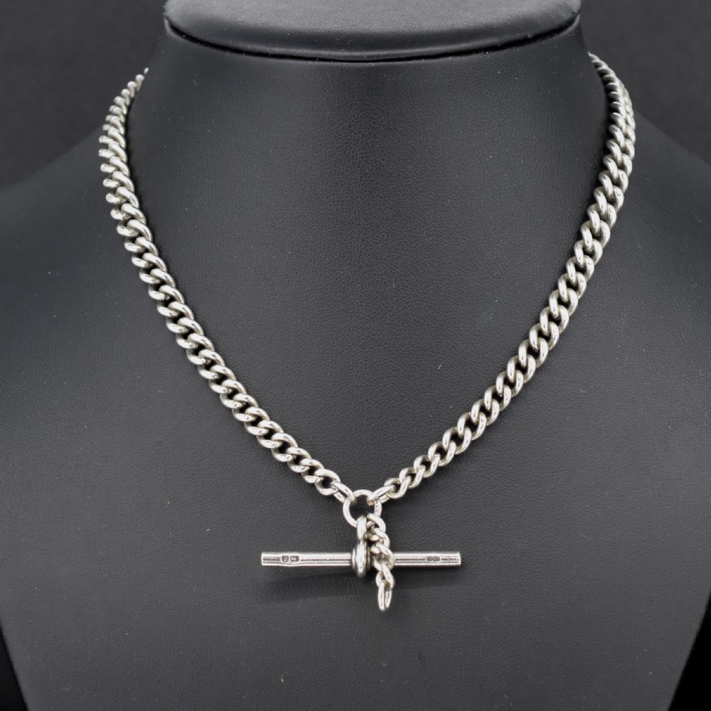 A sterling silver curb link Albert pocket watch chain featuring a T-bar attachment and swivel clasp. View IV