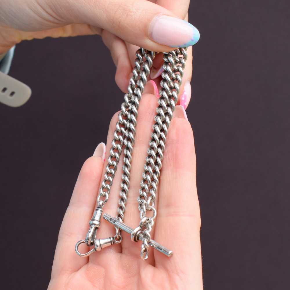 A sterling silver curb link Albert pocket watch chain featuring a T-bar attachment and swivel clasp. View VI
