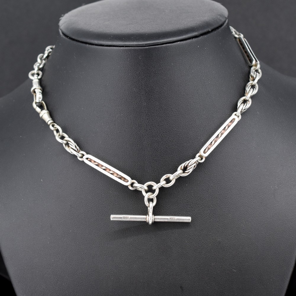 An antique sterling silver Albert chain necklace featuring elongated bar links, twisted rope sections, a T-bar attachment, and a swivel clasp. View II