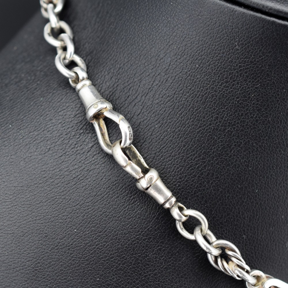 An antique sterling silver Albert chain necklace featuring elongated bar links, twisted rope sections, a T-bar attachment, and a swivel clasp. View IV