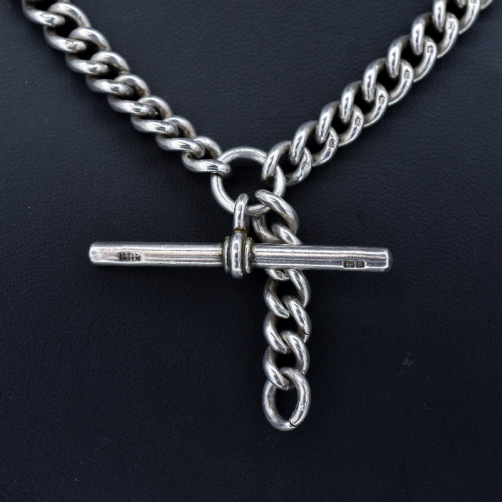 A sterling silver curb link Albert watch chain featuring a T-bar attachment and a swivel clip. View III