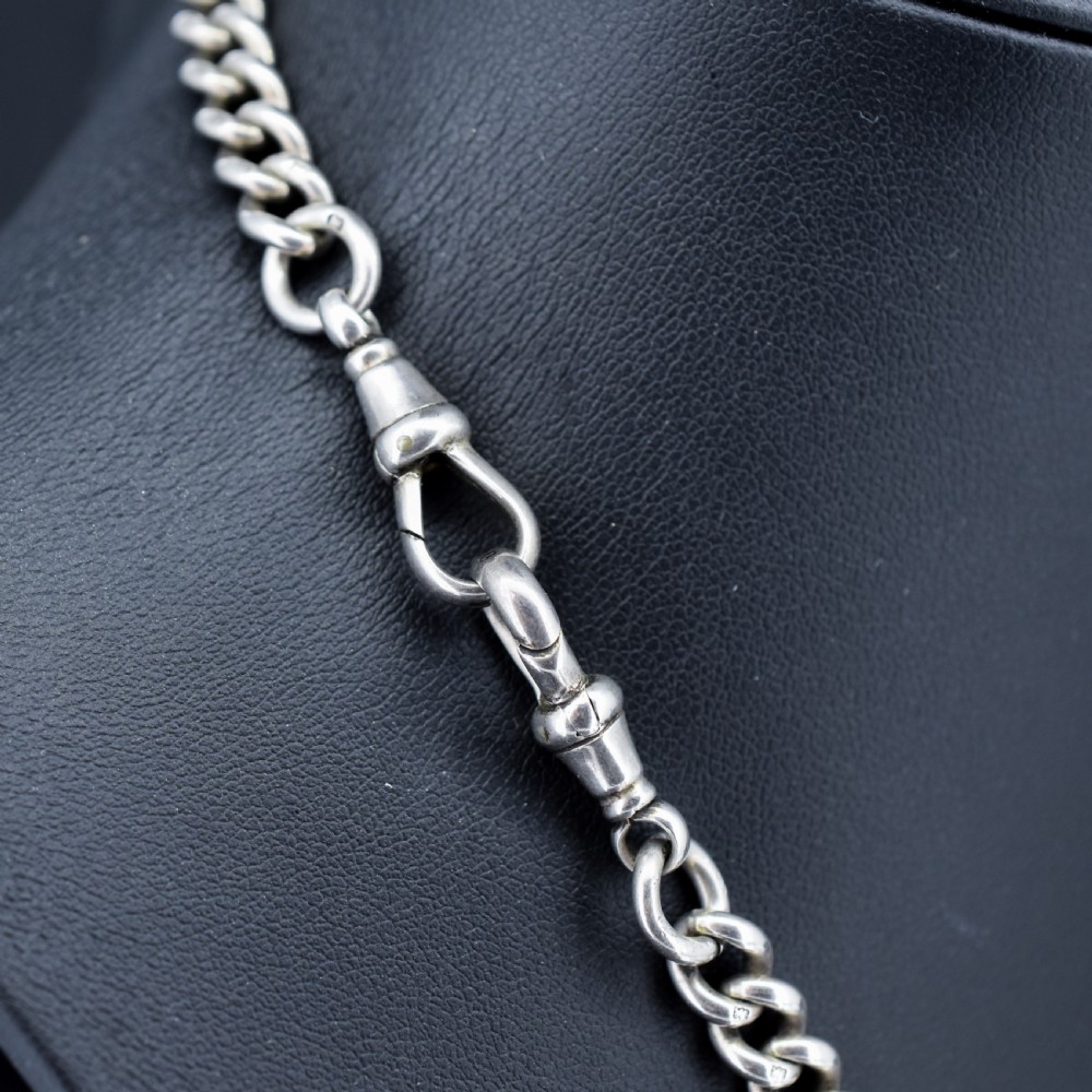 A sterling silver curb link Albert watch chain featuring a T-bar attachment and a swivel clip. View V