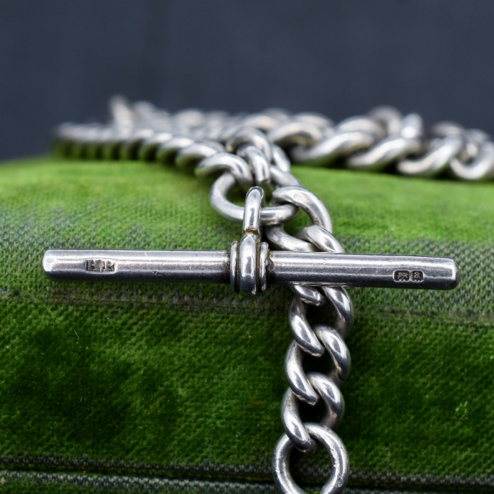 A sterling silver curb link Albert watch chain featuring a T-bar attachment and a swivel clip. View VI