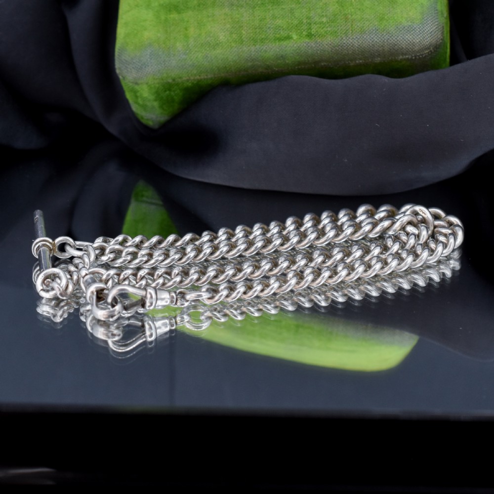 A sterling silver curb link Albert watch chain featuring a T-bar attachment and a swivel clip. View VII