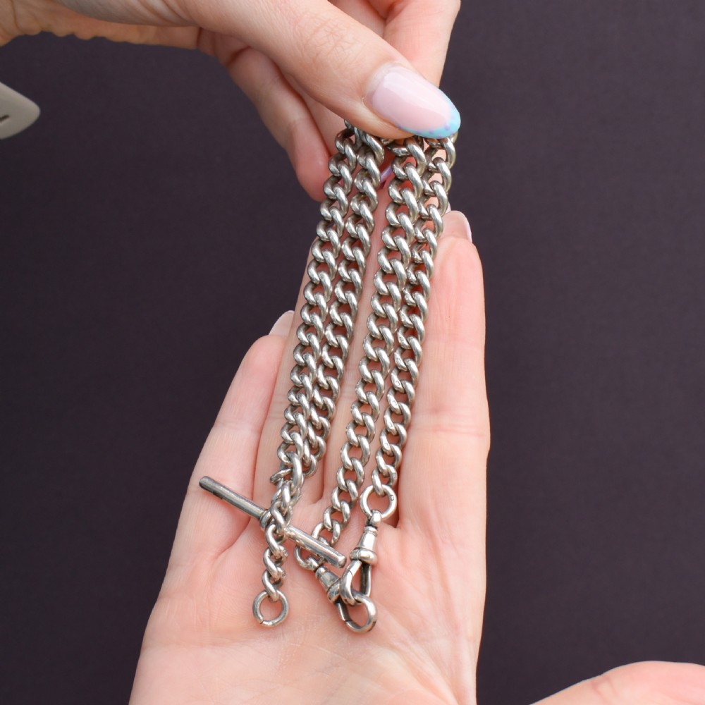 A sterling silver curb link Albert watch chain featuring a T-bar attachment and a swivel clip. View VIII