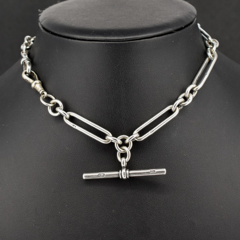 An antique sterling silver trombone link pocket watch chain with a T-bar attachment and dog clip fastener. View II